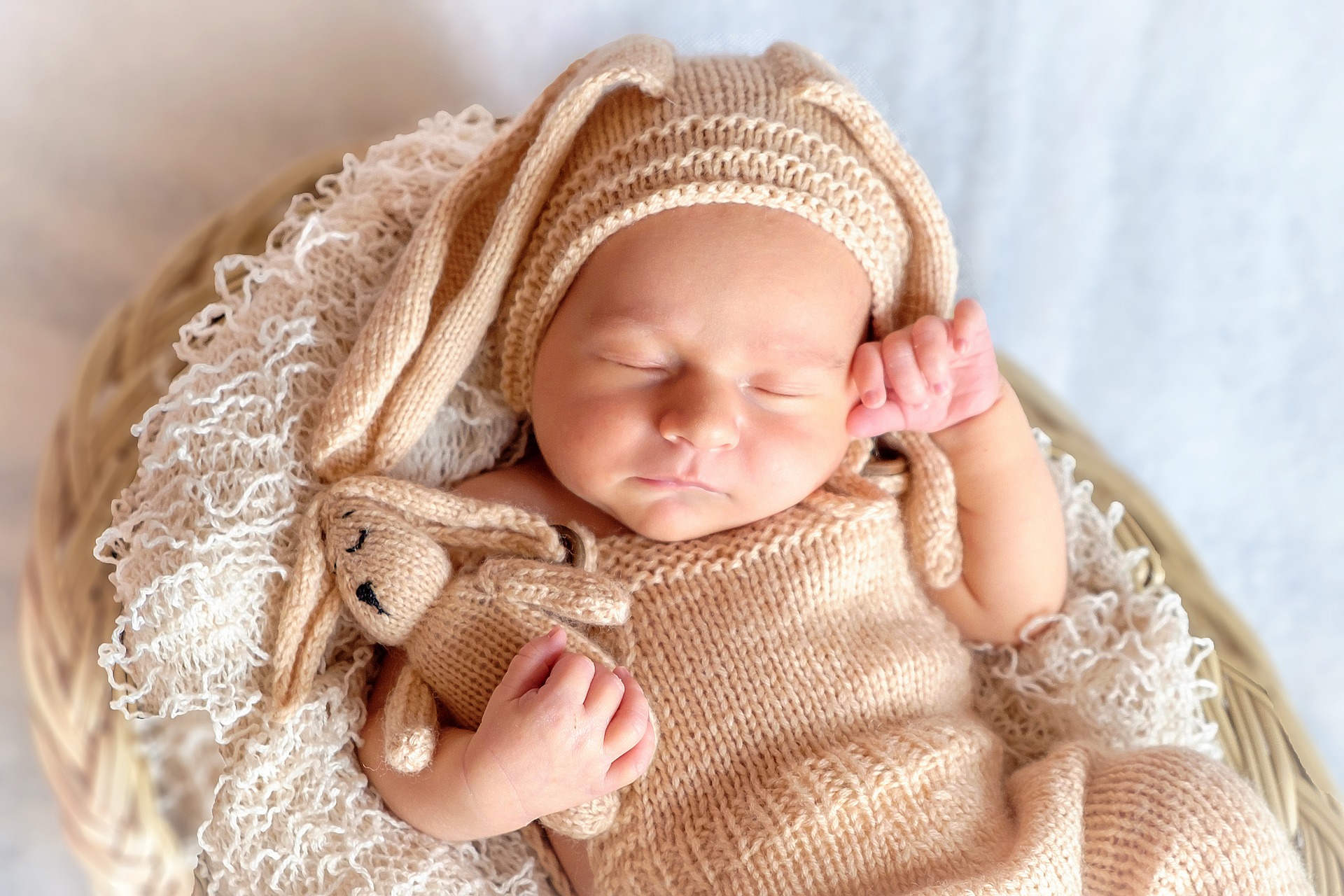 Baby sleeping with stuffed rabbit.